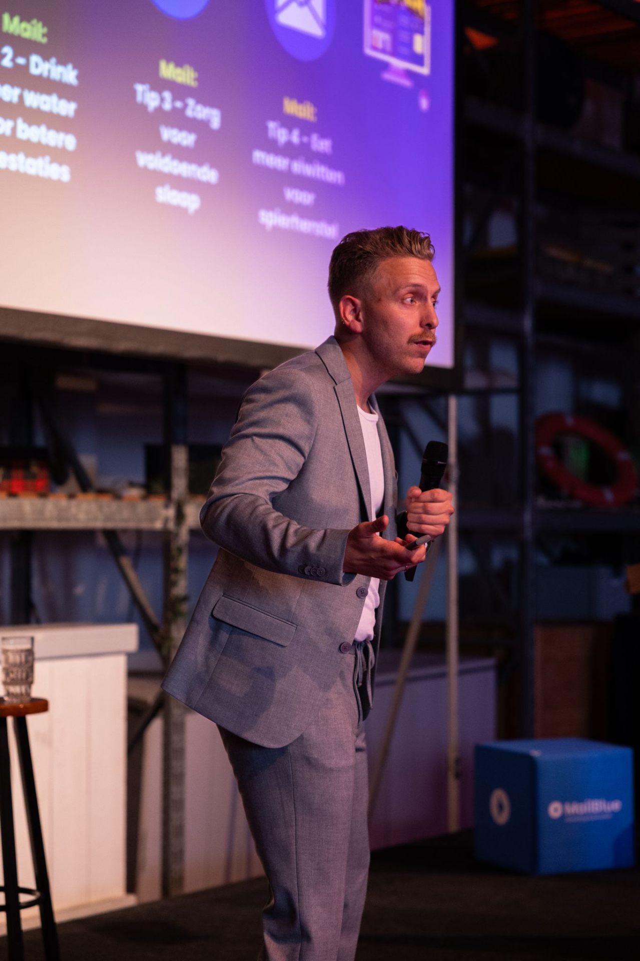 Spreker met microfoon voor slide met tips